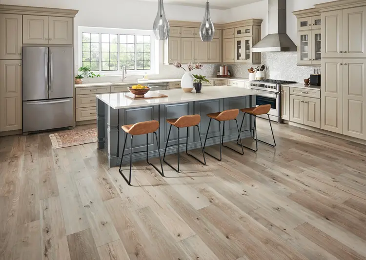 Light wood-look laminate flooring in a spacious kitchen with a central island